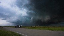 A Truck Turns and Drives Away From a Threatening, Scary Storm.