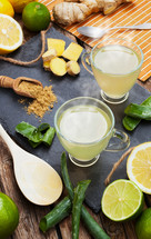 Drink with aloe vera and lemons. Glass cups on a slate tray