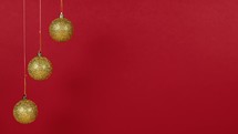 Christmas golden balls against red background