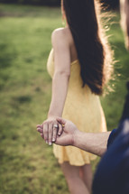 an engaged couple holding hands 