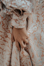 hand of a young woman in an elegant gown 