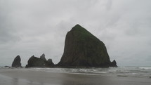 OREGON - Thousand of Birds Flying at Cannon Beach Haystack Rock towers on the shoreline