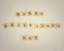 Scrabble tiles spelling out "Happy Valentine's Day."