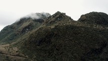 Mountain Peaks With Thin Foggy Clouds At Cayambe Coca Reserve Hike Near Papallacta, Ecuador. Aerial Drone Shot
