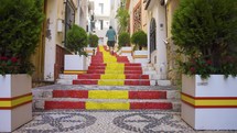 Man Walking Up Pebbled Stairs Painted Spanish Colours In Old Town