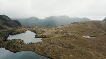 Aerial drone shot of Tranquil Scenery Of Lake And Mountains In Cayambe Coca National Park In Papallacta, Napo, Ecuador.