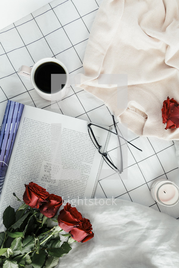 pages, book, reading in bed, sweater, roses, sheets, linens, bed, bedding, bedspread, planner, journal, pencil, reading glasses, candle, coffee mug, grid