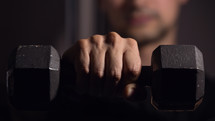 a man holding a dumbbell 