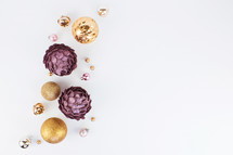 silver, pink, purple, and gold Christmas ornaments on white 