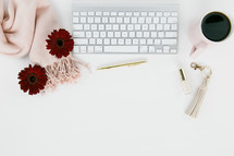 computer keyboard, border, desk, scarf, winter, pink, blush, red, gerber daisies, flowers, gold, pen, keychain, nail polish, home office, workspace, feminine, white background 