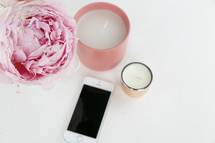 pink peony, candles, and iPhone 