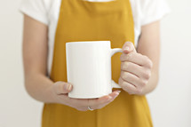 female holding a coffee mug 