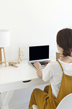 a female sitting at a desk 