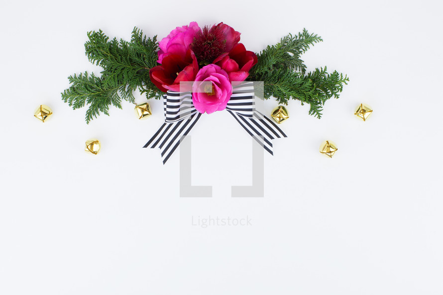 flowers and pine with striped bow and Christmas bells 