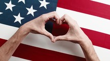 Hand in Heart Shape on American Flag