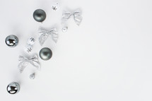 silver Christmas ornaments on a white background 