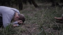 A young man encounters Jesus praying and worshipping at his feet in cinematic slow motion.
