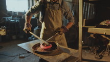Blacksmith Bending Hot Metal Rod into Swirl Form on Anvil in Workshop