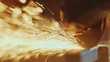 Close-Up of Cutting Metal Billet with Angle Grinder Disk
