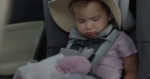 Toddler girl sleeps in car seat while driving - adorable