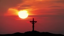 "Cross of Jesus from Calvary hill outside ancient Jerusalem where Christ was crucified.
Big sun and silhouette of Holy Cross."
