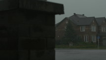 Heavy downpour in suburbia-SUV driving away quickly 