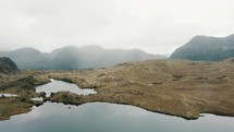 Aerial drone shot of Tranquil Scenery With Lake And Mountains In Cayambe Coca National Park, Papallacta, Napo, Ecuador.