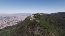 Panoramic drone shot around the Monserrate Sanctuary, in sunny Bogota, Colombia