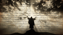 Silhouette of Jesus praying on a hill with mystic clouds behind Him. Old Prophecy scroll
