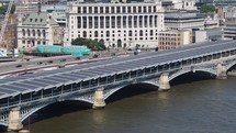 LONDON, UK - CIRCA JUNE 2018: Aerial view of traffic moving on Blackfriars bridge over river Thames - EDITORIAL USE ONLY