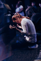 two women surrendering in prayer 