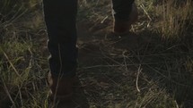 man walking through a field 