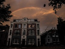 rainbow over a brick building in Amsterdam, Netherlands