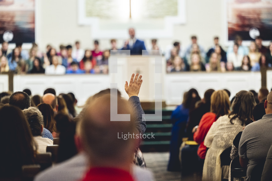 Man, raising his hand during a worship service