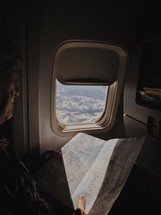 person reading a map on an airplane 