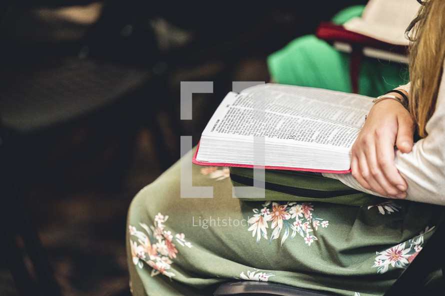 Woman in a church service with a bible on his lap