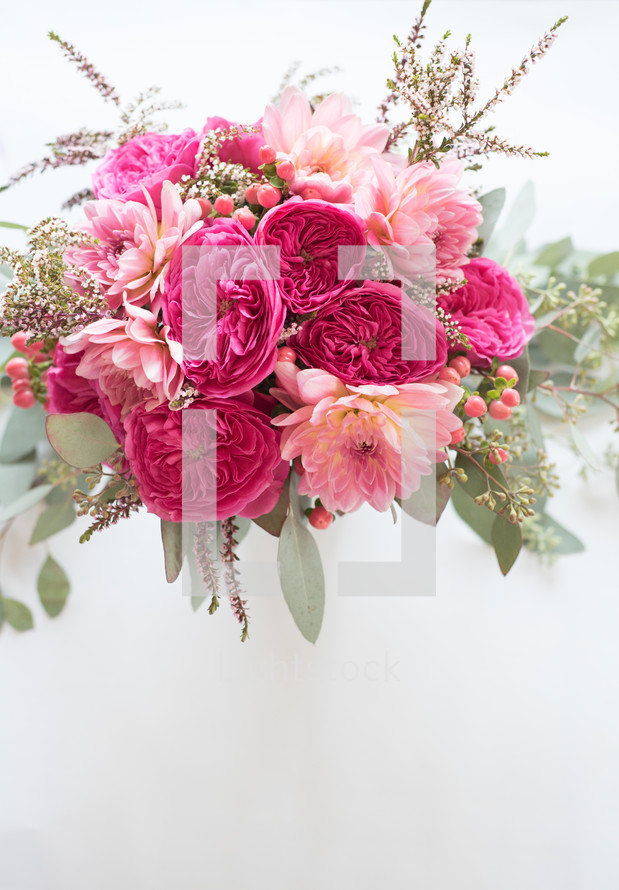 A bouquet of pink flowers on a white background.