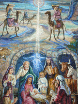 A large colorful mural painting depicting the birth of Jesus showing the wise men appearing on camel and Jesus in the manger surrounded by Mary and Joseph, shepherds and angels. 