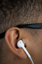man listening to earbuds 