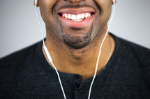 face of a man with earbuds 