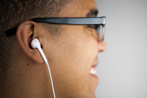 man with earbuds listening to music 
