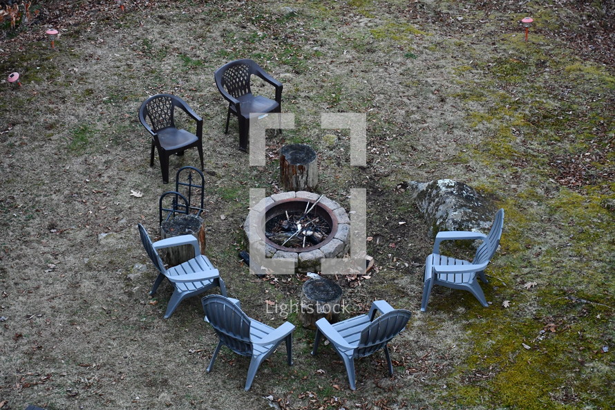 empty chairs around a fire pit 