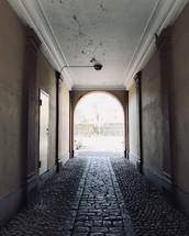 covered cobblestone walkway and peeling paint on a ceiling 