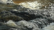 Water in a mountain stream flowing over rocks