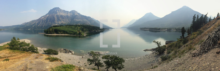 a panoramic shot of mountains and lake with iphone