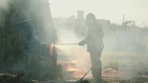 Torcher in Slow Motion, Torching Metal at a Scrapyard