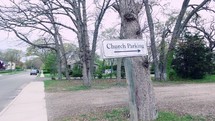 walking by a church parking sign 