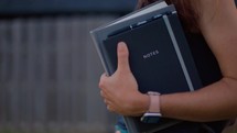 Woman Reading Bible and Journaling Outside at Sunset