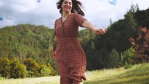 happy young woman spinning outdoors 