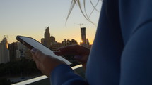 Woman on a phone at sunset in an urban setting